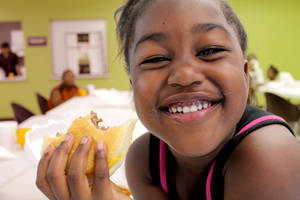 Beautiful smiling girl with sandwich