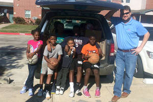 Kids and Graham (staff) at car for transport